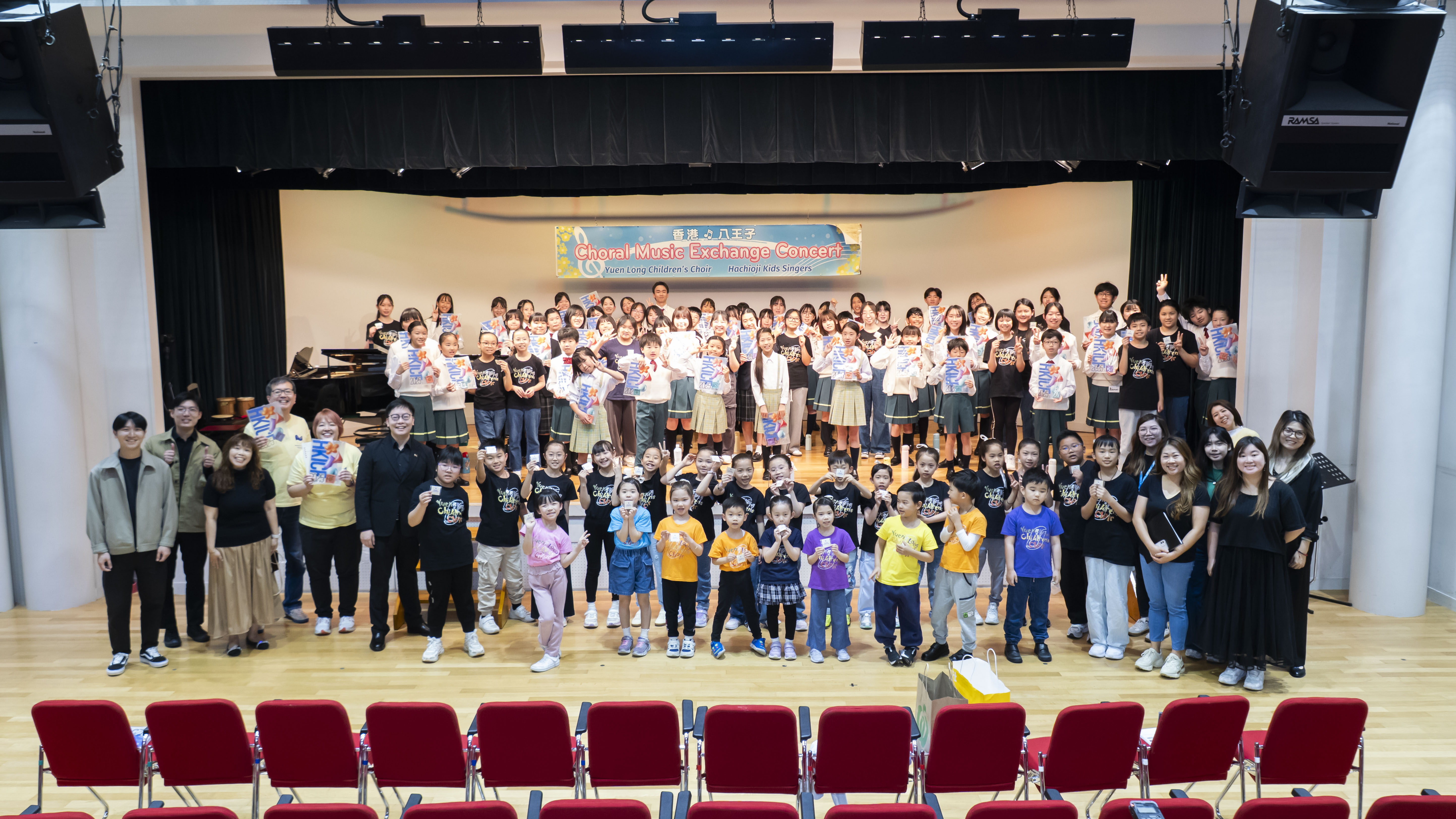 Yuen Long Children's Choir and Hachioji Kids Singer with their conductors and families on stage at the Choral Music Exchange Concert in Hachioji, Japan